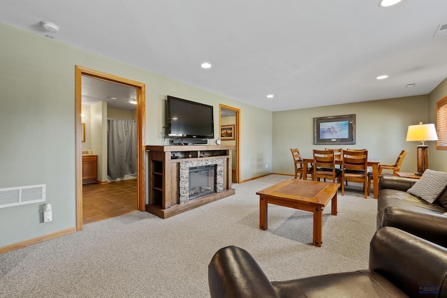 24354 Rushmore Ranch Rd, Keystone, SD 57751 - living room with visible vents, recessed lighting, a tile fireplace, and carpet flooring