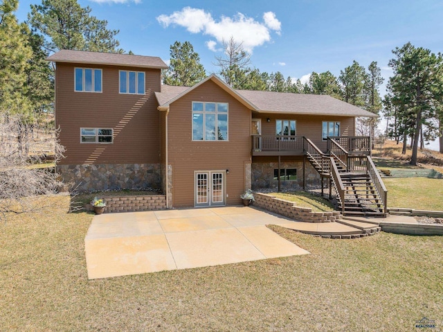 24354 Rushmore Ranch Rd, Keystone, SD 57751 - back of house featuring a lawn, a wooden deck, stairway, and a patio area