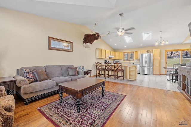 24354 Rushmore Ranch Rd, Keystone, SD 57751 - living area featuring lofted ceiling with skylight, recessed lighting, light wood-style floors, and ceiling fan