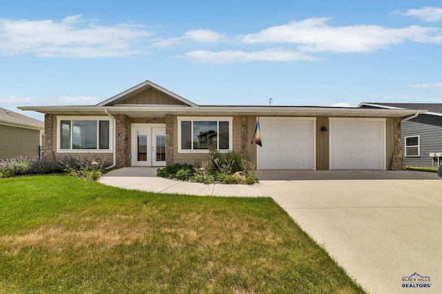 3129 Hazelnut Ln, Rapid City, SD 57703 - ranch-style home with an attached garage, a front lawn, stone siding, french doors, and driveway