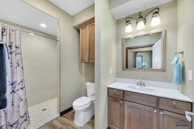 3129 Hazelnut Ln, Rapid City, SD 57703 - full bath featuring a tile shower, vanity, toilet, baseboards, and wood finished floors