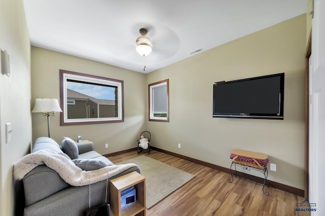 3129 Hazelnut Ln, Rapid City, SD 57703 - living room with baseboards, a ceiling fan, wood finished floors, and visible vents