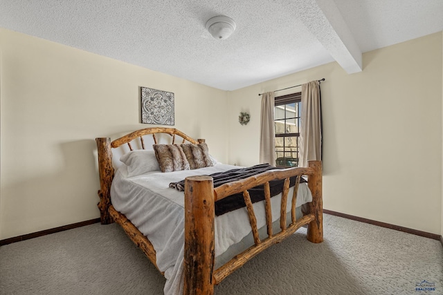 bedroom with carpet flooring, baseboards, beamed ceiling, and a textured ceiling