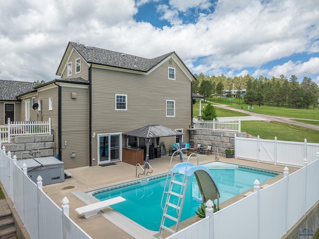 view of pool with a diving board, a fenced backyard, a water slide, a fenced in pool, and a patio area