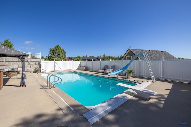 view of pool with a diving board, a fenced in pool, a water slide, a fenced backyard, and a patio