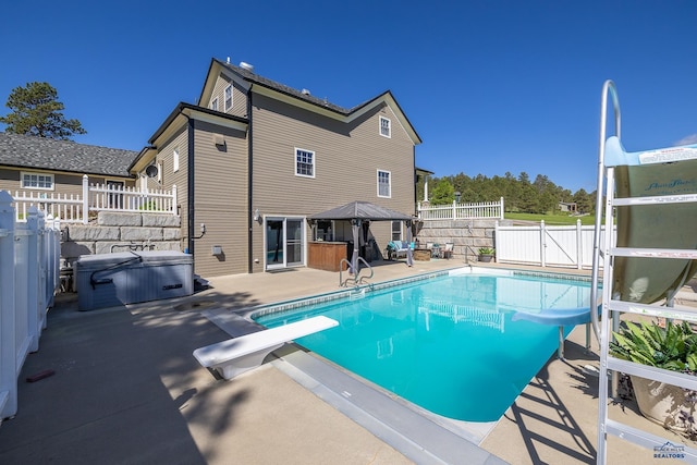 view of pool with a gate, fence, a patio, a gazebo, and a hot tub