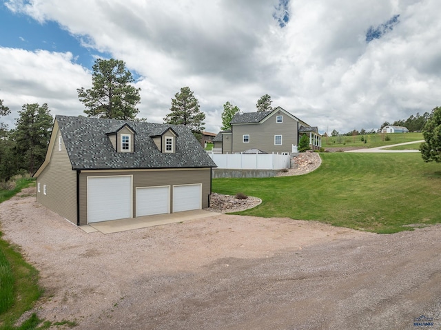 detached garage featuring fence