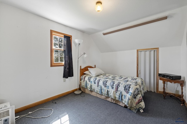 bedroom with baseboards, vaulted ceiling, and carpet flooring