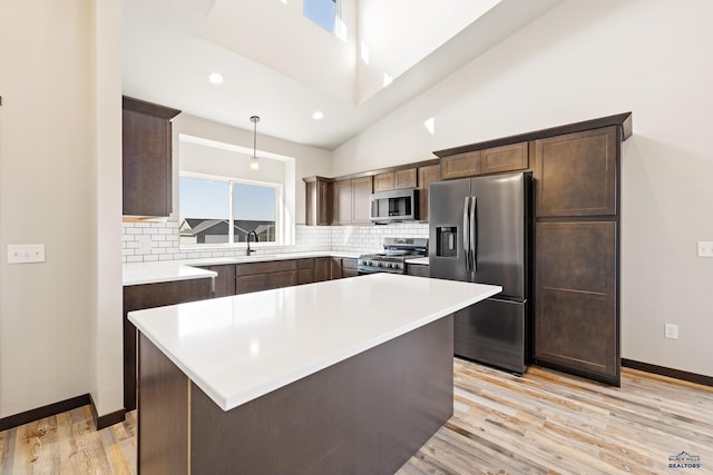 kitchen with plenty of natural light, a sink, dark brown cabinetry, and appliances with stainless steel finishes