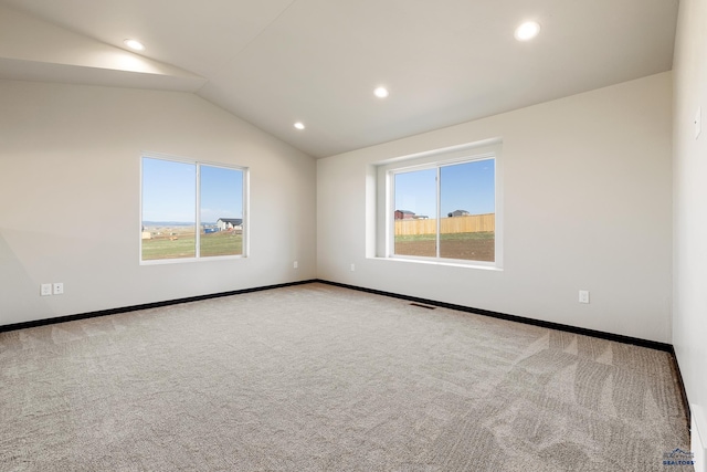 carpeted spare room featuring baseboards, visible vents, lofted ceiling, and recessed lighting