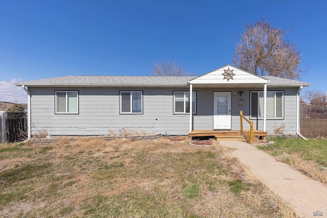 524 Mall Dr, Rapid City, SD 57701 - ranch-style home featuring a front yard, a porch, fence, and roof with shingles