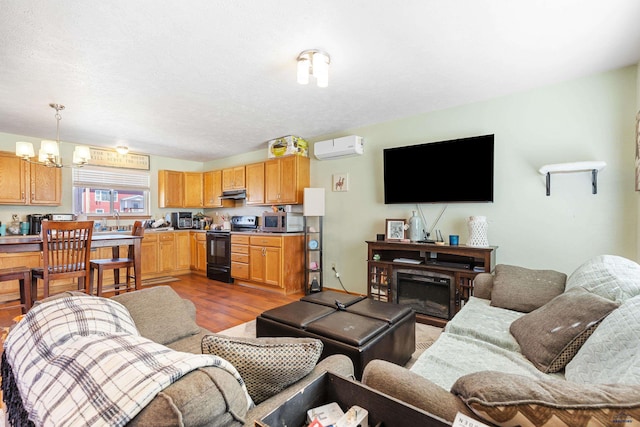 524 Mall Dr, Rapid City, SD 57701 - living room featuring a wall mounted air conditioner, a fireplace, and wood finished floors