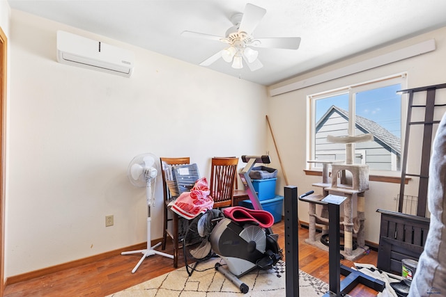 524 Mall Dr, Rapid City, SD 57701 - interior space with baseboards, a wall mounted AC, wood finished floors, and a ceiling fan