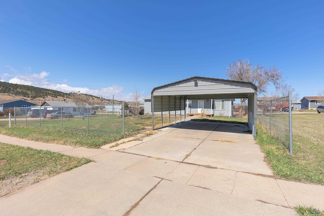 524 Mall Dr, Rapid City, SD 57701 - view of front facade with driveway, a carport, fence, and a front lawn