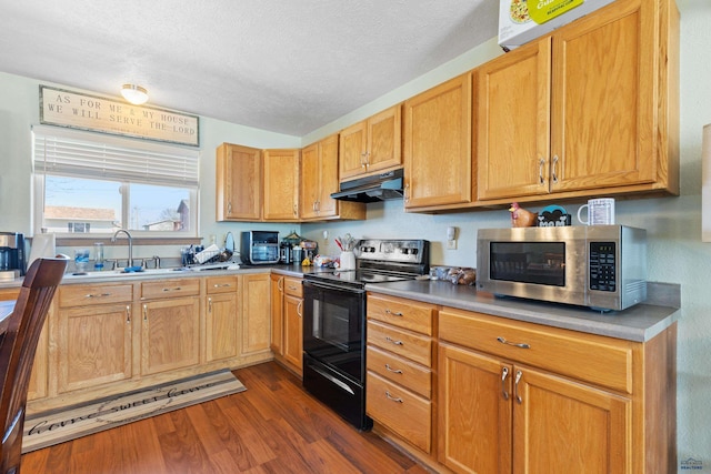 524 Mall Dr, Rapid City, SD 57701 - kitchen featuring stainless steel microwave, under cabinet range hood, dark wood finished floors, electric range, and a sink