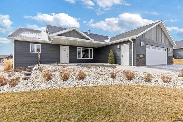 4403 Targhee Dr, Rapid City, SD 57702 - single story home featuring a garage, board and batten siding, concrete driveway, and a front yard