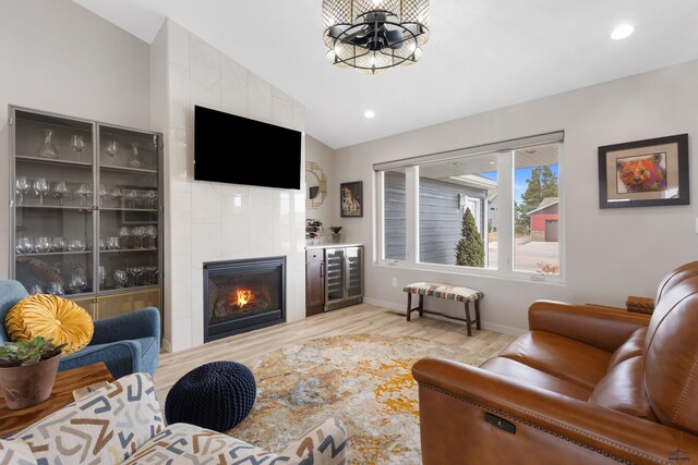 4403 Targhee Dr, Rapid City, SD 57702 - living area featuring lofted ceiling, recessed lighting, light wood-type flooring, wine cooler, and a notable chandelier
