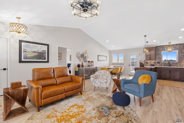 4403 Targhee Dr, Rapid City, SD 57702 - living room with vaulted ceiling, light wood-type flooring, recessed lighting, and an inviting chandelier