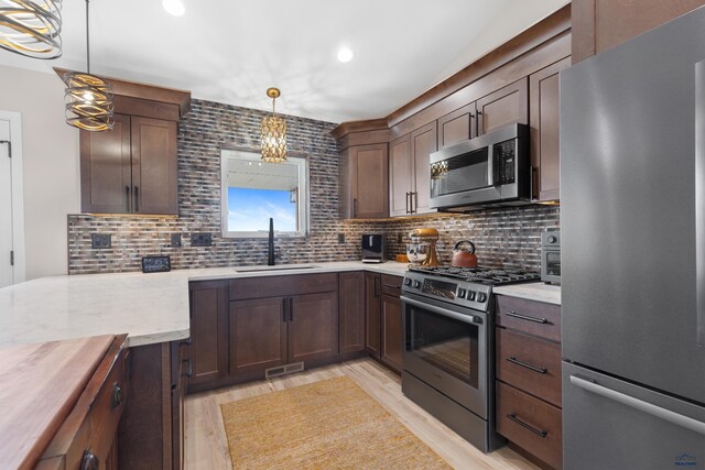 4403 Targhee Dr, Rapid City, SD 57702 - kitchen featuring a sink, tasteful backsplash, stainless steel appliances, visible vents, and light wood-style floors