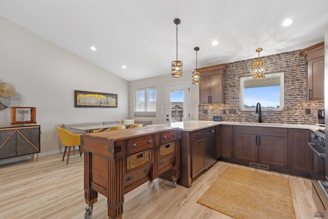 4403 Targhee Dr, Rapid City, SD 57702 - kitchen with light countertops, backsplash, a sink, light wood-style floors, and a peninsula