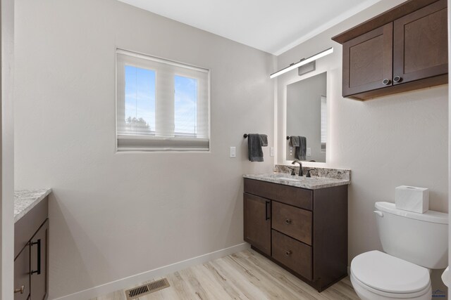 4403 Targhee Dr, Rapid City, SD 57702 - bathroom with toilet, vanity, wood finished floors, and visible vents