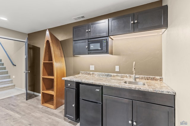 2750 Tumble Weed Trl, Spearfish, SD 57783 - bar featuring visible vents, a sink, freestanding refrigerator, black microwave, and stairs