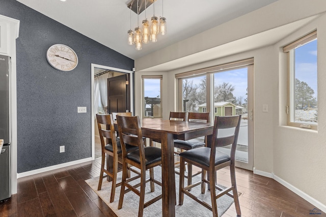 2750 Tumble Weed Trl, Spearfish, SD 57783 - dining room with an inviting chandelier, dark wood-style flooring, baseboards, and lofted ceiling