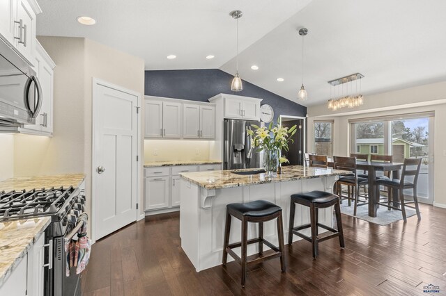 2750 Tumble Weed Trl, Spearfish, SD 57783 - kitchen with light stone countertops, dark wood finished floors, lofted ceiling, and stainless steel appliances