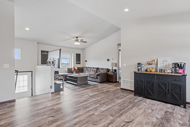 living area featuring visible vents, ceiling fan, recessed lighting, vaulted ceiling, and wood finished floors