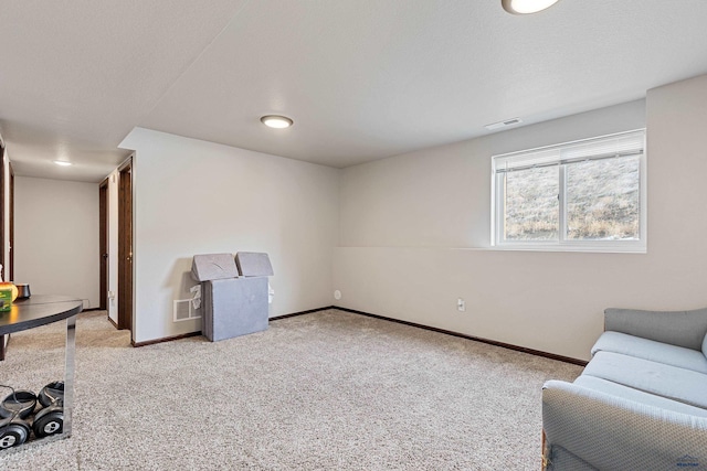 sitting room featuring light carpet, visible vents, and baseboards