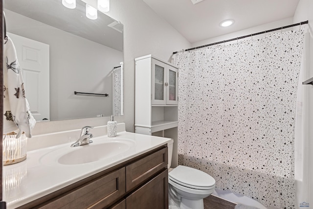 bathroom featuring shower / tub combo with curtain, vanity, and toilet
