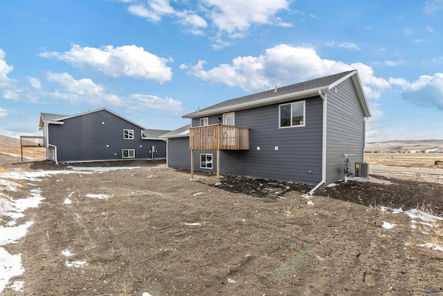 rear view of house featuring central AC