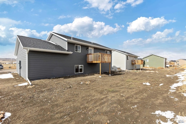back of property featuring a shingled roof