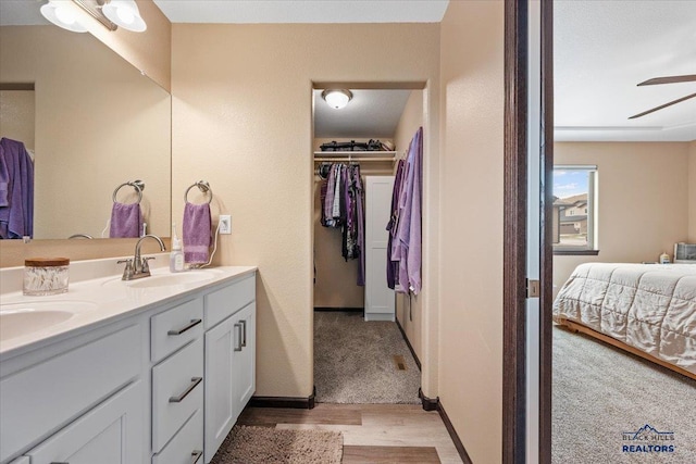 2678 Meadows Dr, Sturgis, SD 57785 - ensuite bathroom with ensuite bathroom, a ceiling fan, a sink, a walk in closet, and double vanity