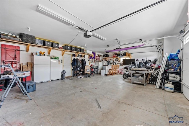 2678 Meadows Dr, Sturgis, SD 57785 - garage with a garage door opener and freestanding refrigerator