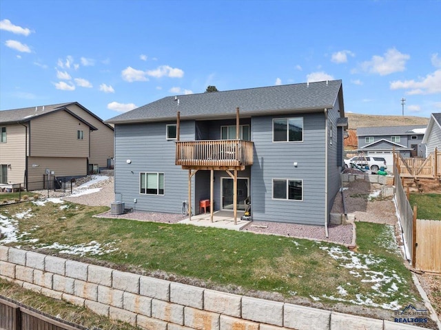 2678 Meadows Dr, Sturgis, SD 57785 - back of property with a lawn, a fenced backyard, cooling unit, a patio, and a balcony