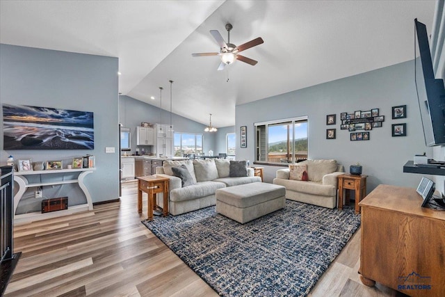 2678 Meadows Dr, Sturgis, SD 57785 - living area with ceiling fan with notable chandelier, high vaulted ceiling, light wood-style flooring, recessed lighting, and baseboards