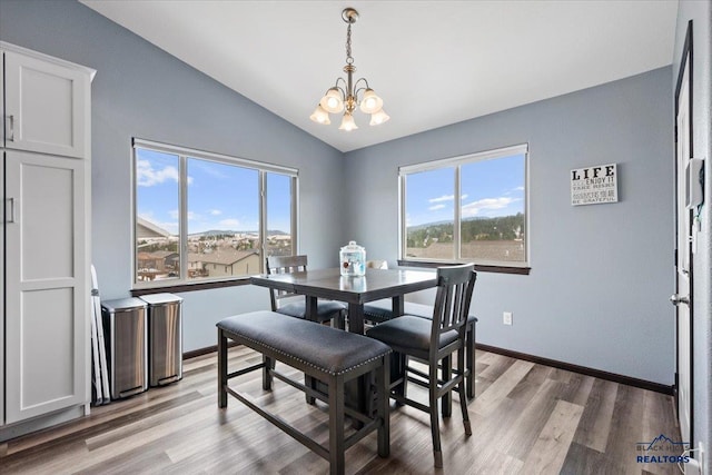 2678 Meadows Dr, Sturgis, SD 57785 - dining room with a wealth of natural light, light wood-type flooring, an inviting chandelier, and vaulted ceiling