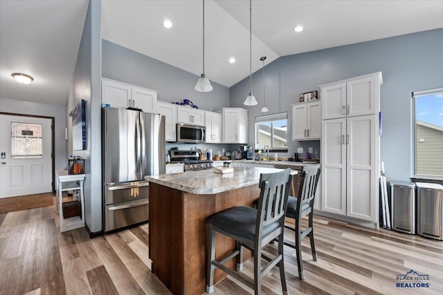 2678 Meadows Dr, Sturgis, SD 57785 - kitchen featuring a center island, appliances with stainless steel finishes, a sink, and light wood-style floors