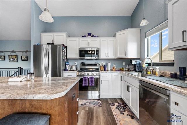 2678 Meadows Dr, Sturgis, SD 57785 - kitchen featuring a sink, white cabinets, wood finished floors, and stainless steel appliances