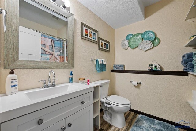 2678 Meadows Dr, Sturgis, SD 57785 - full bath with curtained shower, toilet, a textured wall, vanity, and wood finished floors