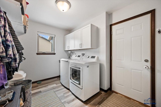 2678 Meadows Dr, Sturgis, SD 57785 - laundry room featuring cabinet space, baseboards, light wood finished floors, and washer and dryer