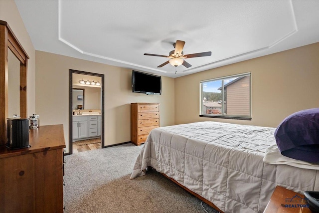 2678 Meadows Dr, Sturgis, SD 57785 - bedroom with ensuite bathroom, baseboards, a ceiling fan, and light colored carpet
