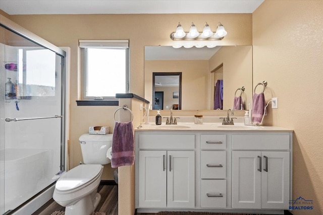 2678 Meadows Dr, Sturgis, SD 57785 - bathroom featuring a sink, toilet, a shower stall, and double vanity