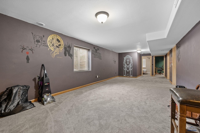 interior space with baseboards and carpet