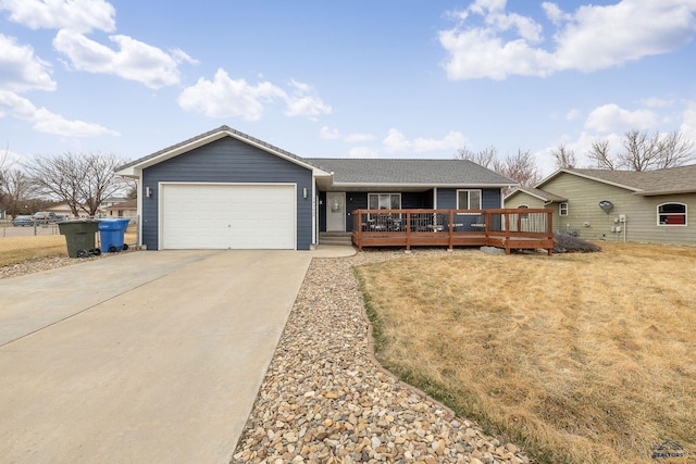 ranch-style home with an attached garage, driveway, and fence