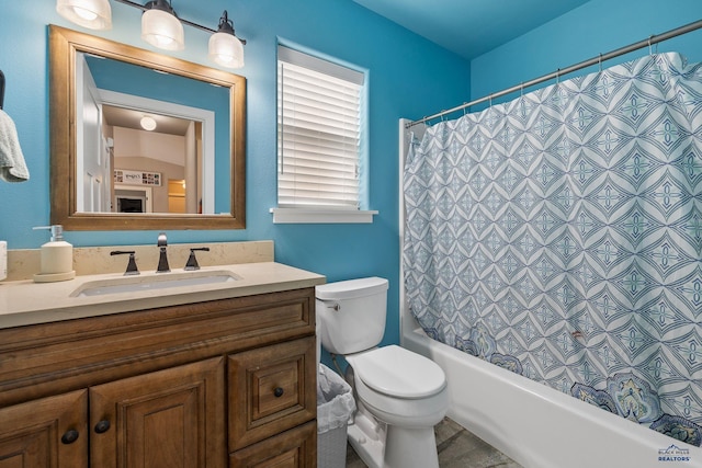 full bath featuring toilet, vanity, and shower / bath combination with curtain