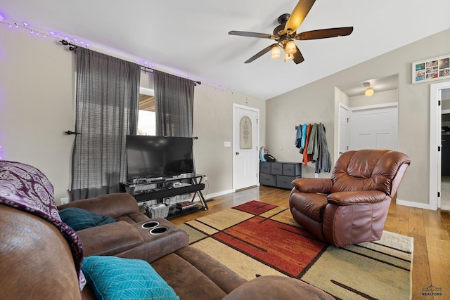living room with wood finished floors, baseboards, a ceiling fan, and lofted ceiling