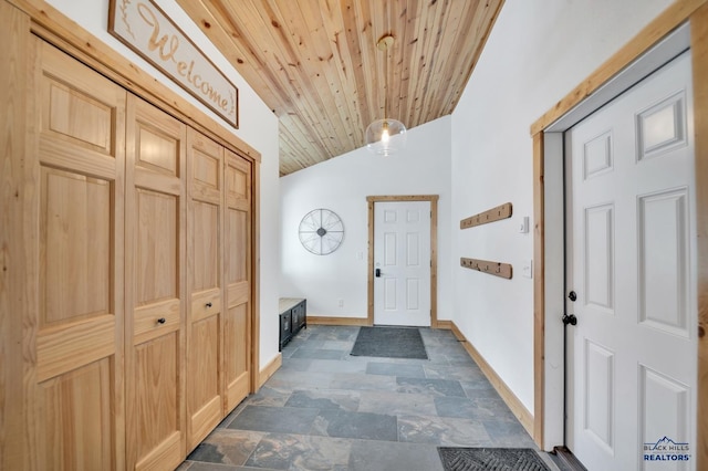 foyer featuring wooden ceiling, baseboards, and lofted ceiling
