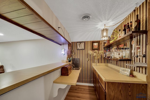 3112 Flint Dr, Rapid City, SD 57702 - bar featuring indoor wet bar, a textured ceiling, dark wood finished floors, and visible vents